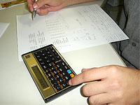 Pessoa fazendo conta usando a calculadora