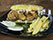 Sanduíche de camarão empanado, com alface americana, crispy bacon e maionese citrica, servido na ciabatta de abóbora. Acompanha batatas canoa com parmesan garlic