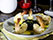Camarões VG (5 un) empanados na farinha de tapioca. Acompanha arroz negro com limão siciliano e molho de manga com laranja e mel