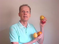 Armando Falconi segurando tomates e ma&ccedil;&atilde;s