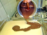 foto colocando o creme de chocolate em cima do primeiro preparo
